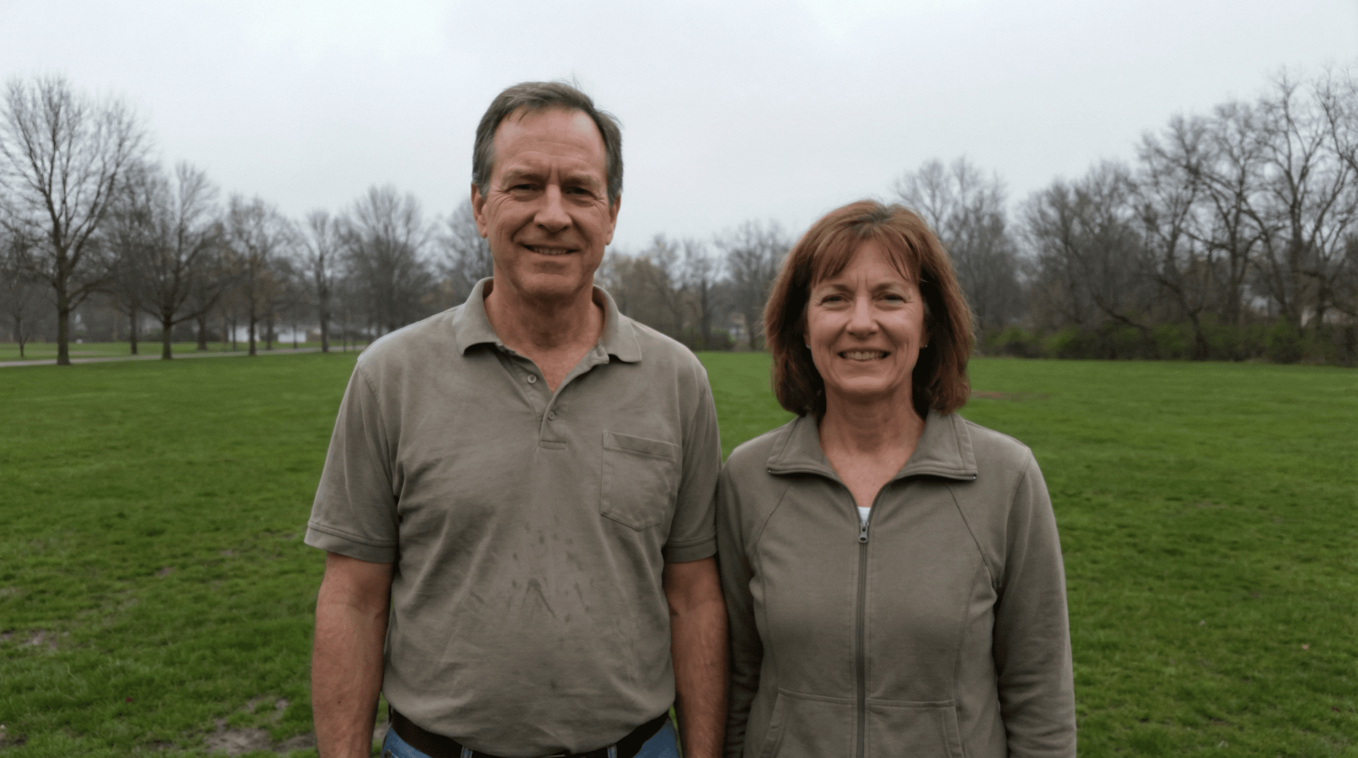 Couple standing stiffly in a park — flat overcast light, tourist photo